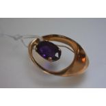 Ronald Hayes Pearson, a 14ct gold and amethyst brooch, of elliptical form, claw set with a large