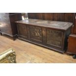 A large 19th century coffer, elaborately relief carved and painted with a variety of subjects, the