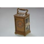 A French gilt-brass repeating carriage clock, c. 1900, the gilt dial with silvered chapter ring