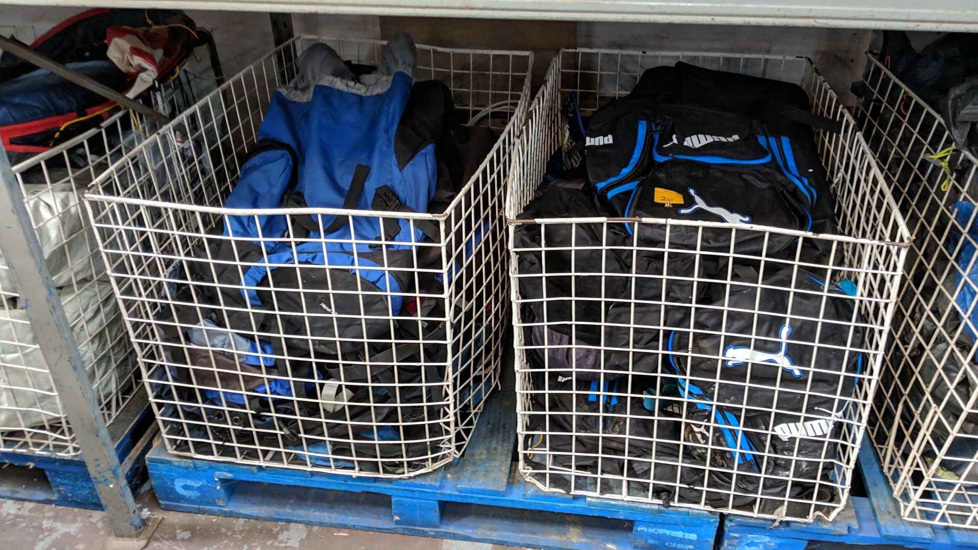 Contents of 2 large cages of assorted holdalls by Puma, Adidas & others - cages excluded