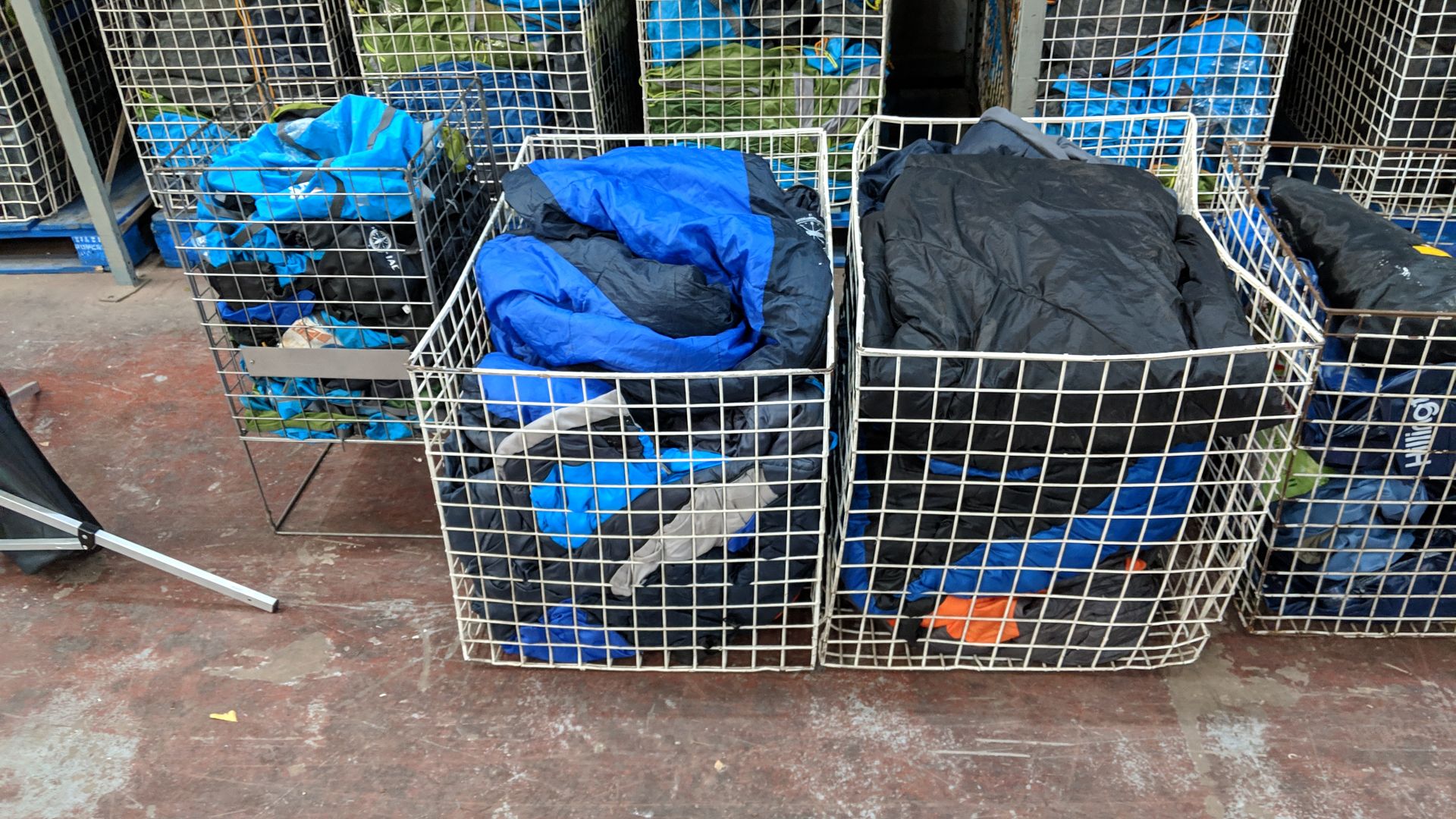 Contents of 2 cages of sleeping bags plus 1 smaller cage of bags for putting sleeping bags in -