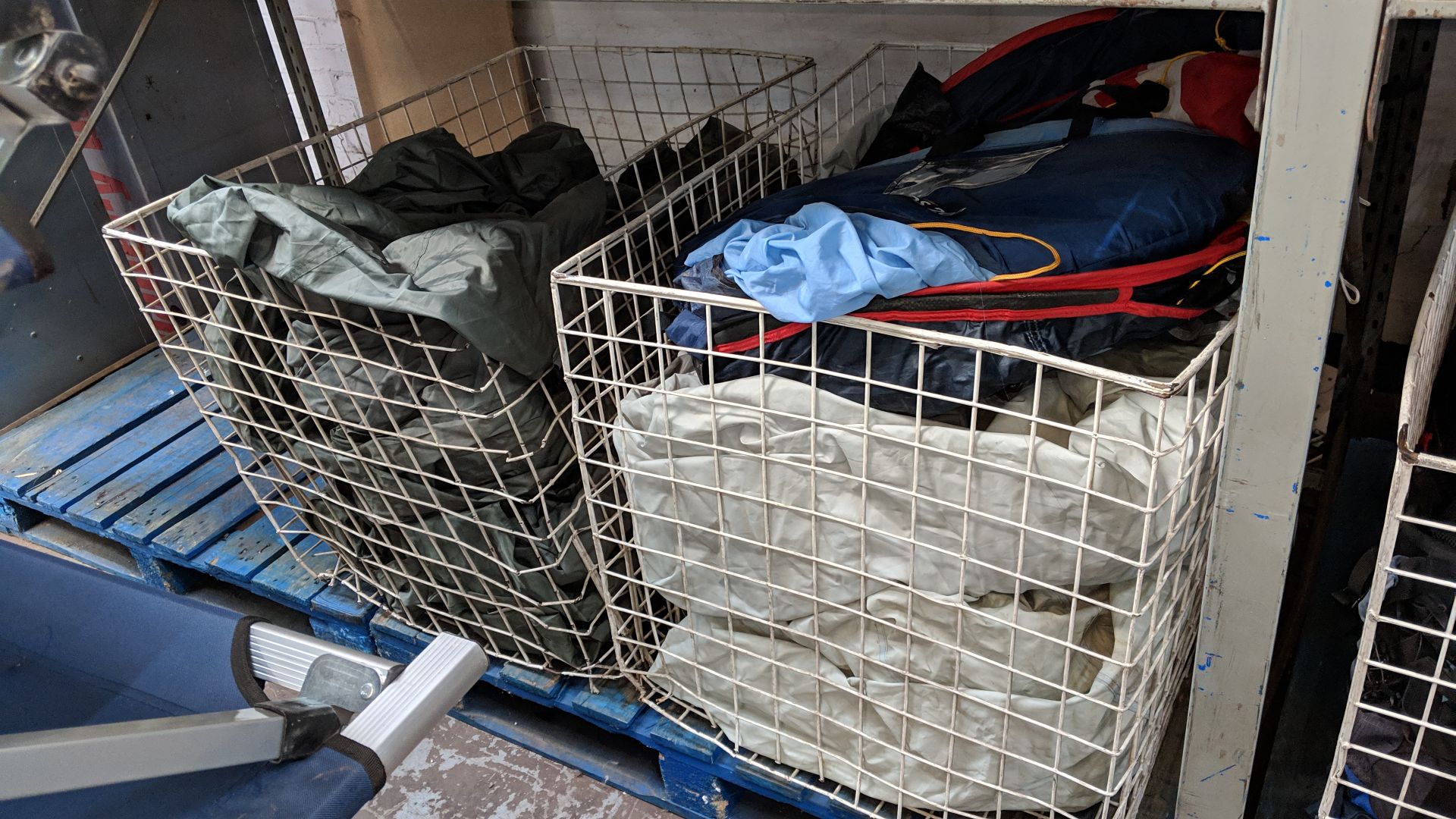 Contents of 2 large cages which appear to consist of 4 large tents plus other related items - unsure
