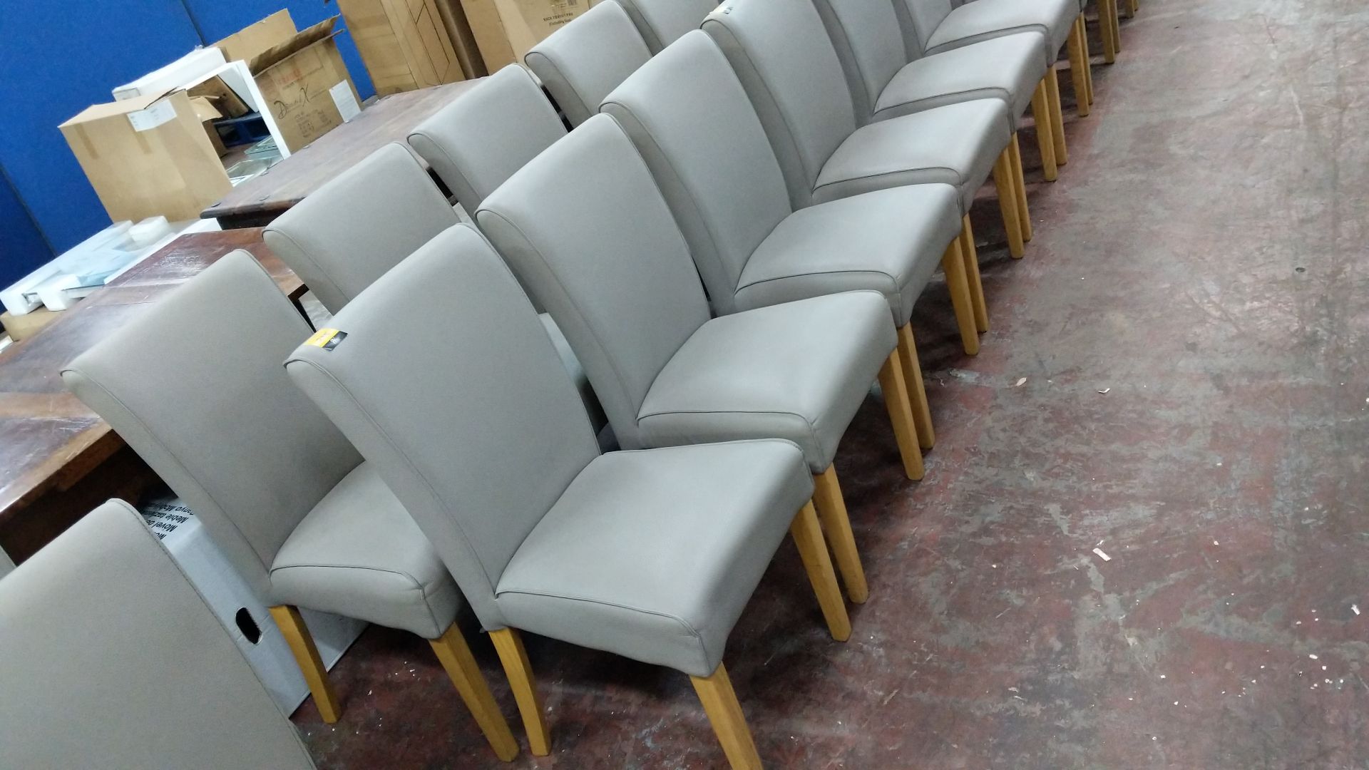 6 off dining chairs with wooden legs, upholstered in taupe leatherette type fabric, understood to