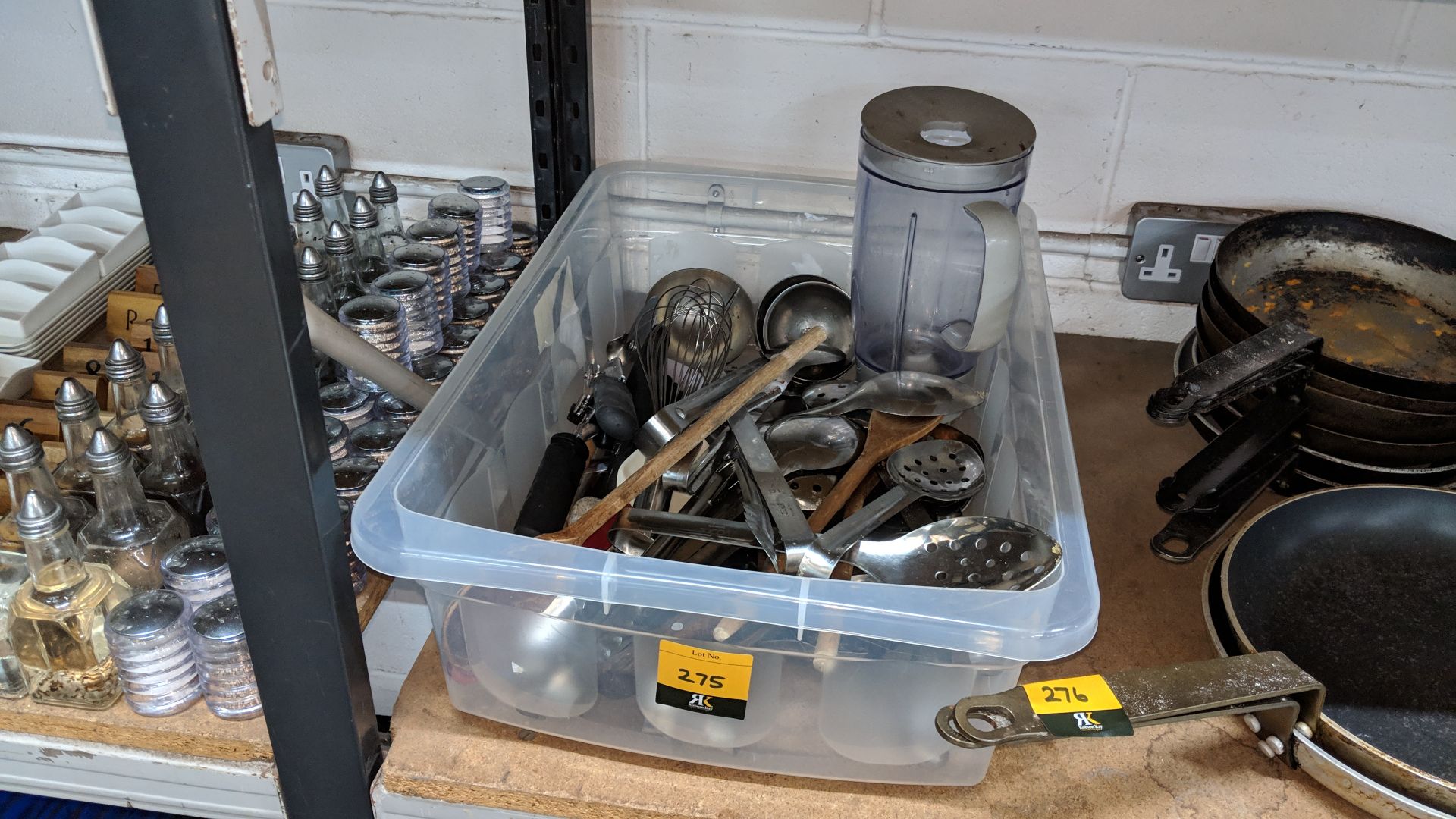 Contents of a crate of assorted ladles, spoons, ice cream scoops, peelers and other kitchen utensils