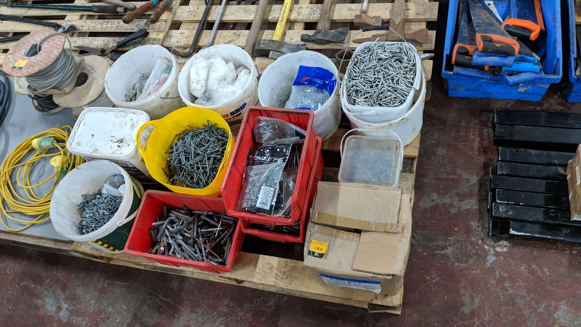 Contents of a pallet of assorted fixings, including screws, clips, pins & more - pallet excluded