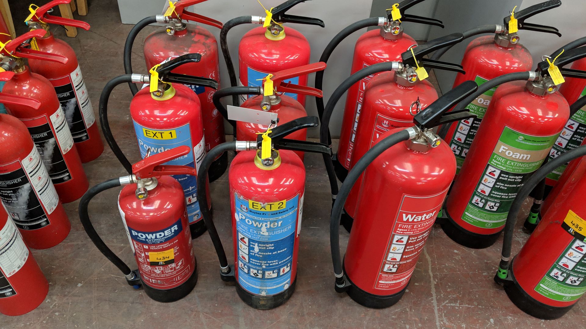 9 off assorted powder and water fire extinguishers, typically showing last service dates of 2017/