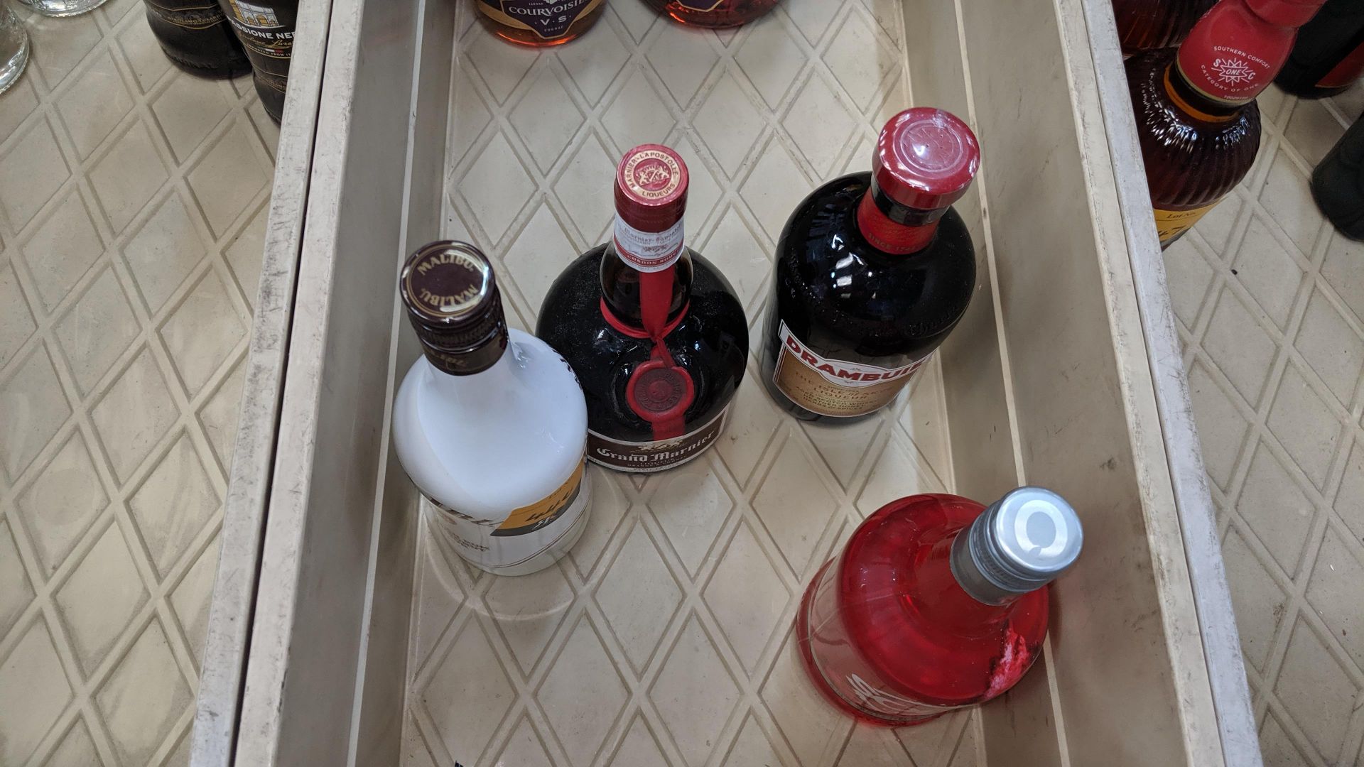 4 off assorted 70cl bottles comprising 1 bottle of Malibu, 1 bottle of Grand Marnier, 1 bottle of