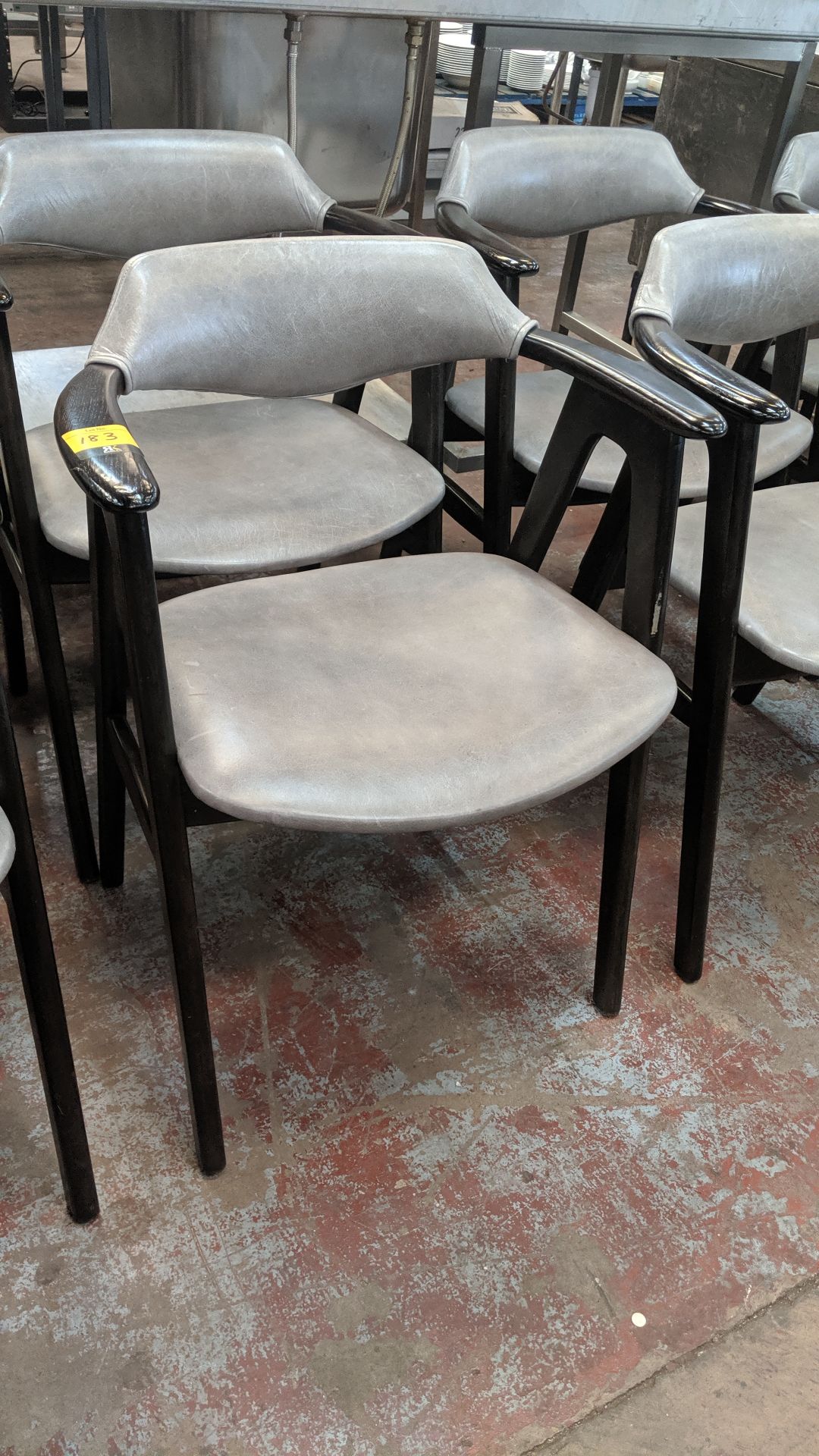 10 off upholstered wooden dining chairs with arms in a pale grey leather/leather type covering. NB - Image 3 of 4