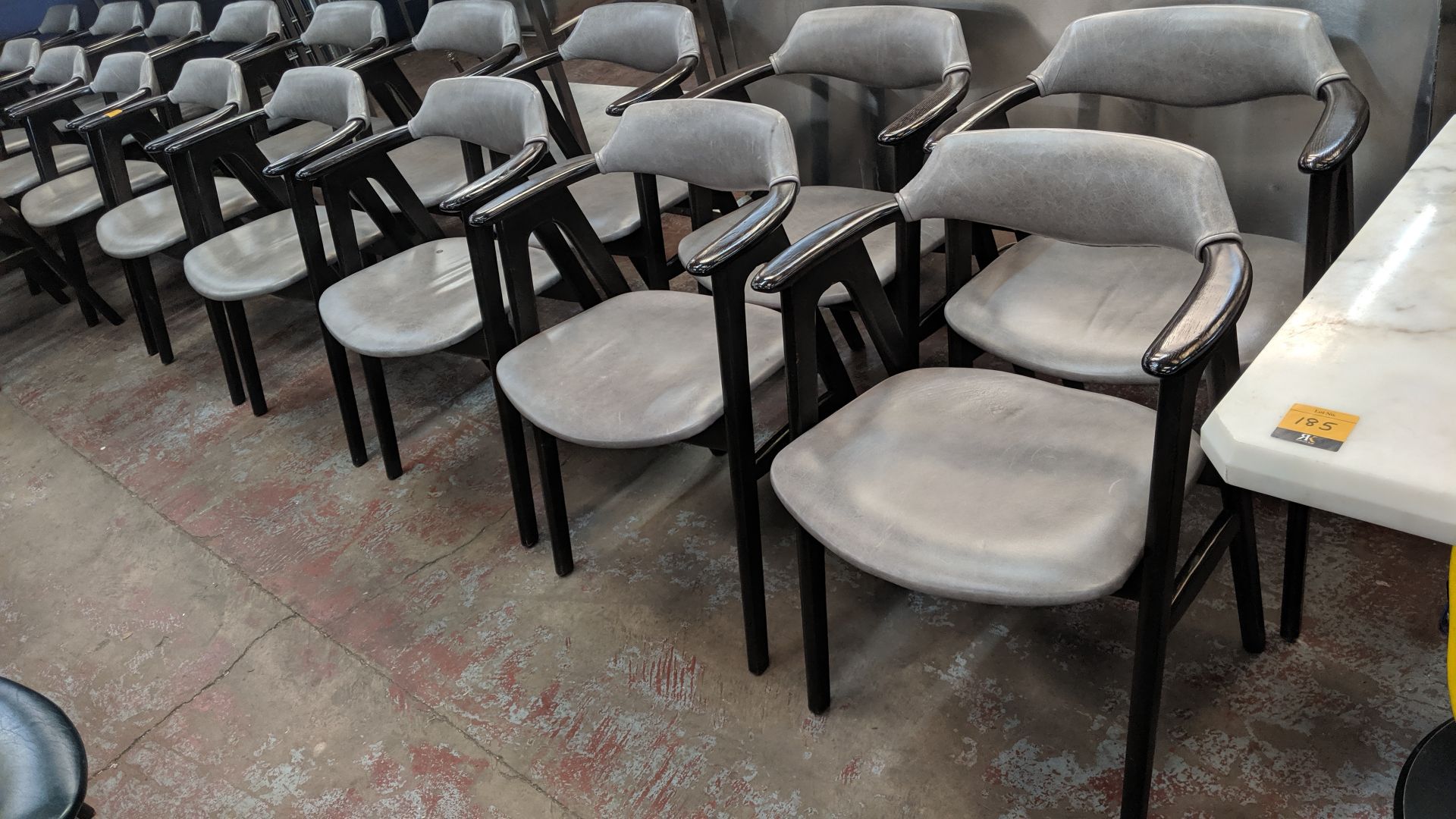 10 off upholstered wooden dining chairs with arms in a pale grey leather/leather type covering. NB - Image 4 of 4