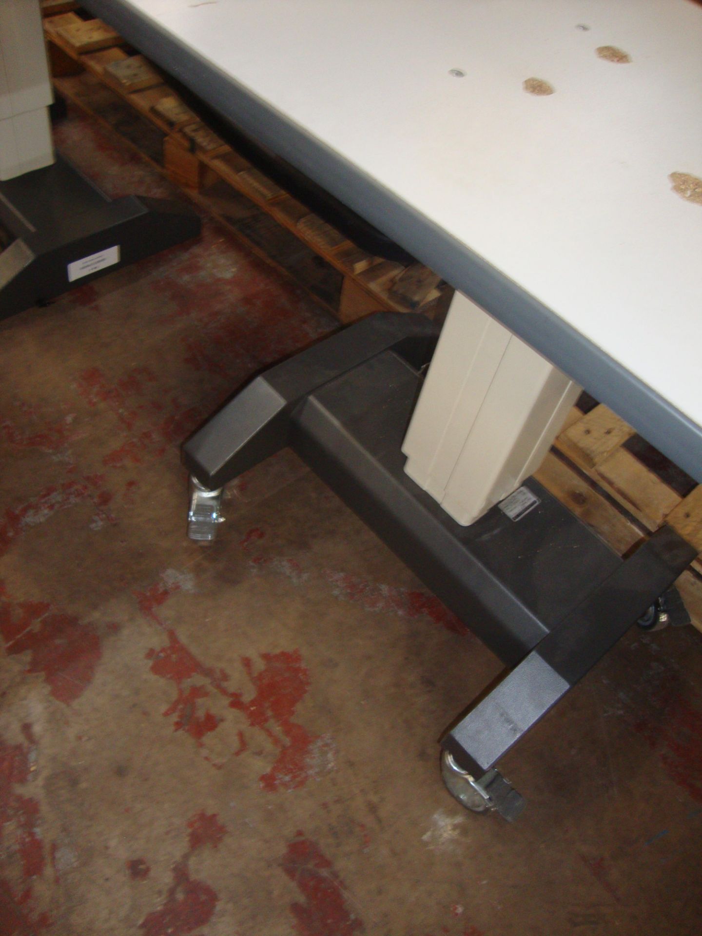 Electric motorized rising table 910mm x 490mm. NB. tabletop has pulled away from the screws that - Image 2 of 2