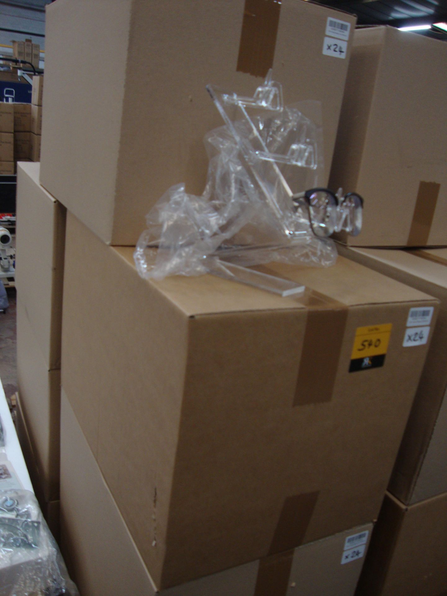 9 boxes containing a total of approx. 110 acrylic freestanding display stands capable of