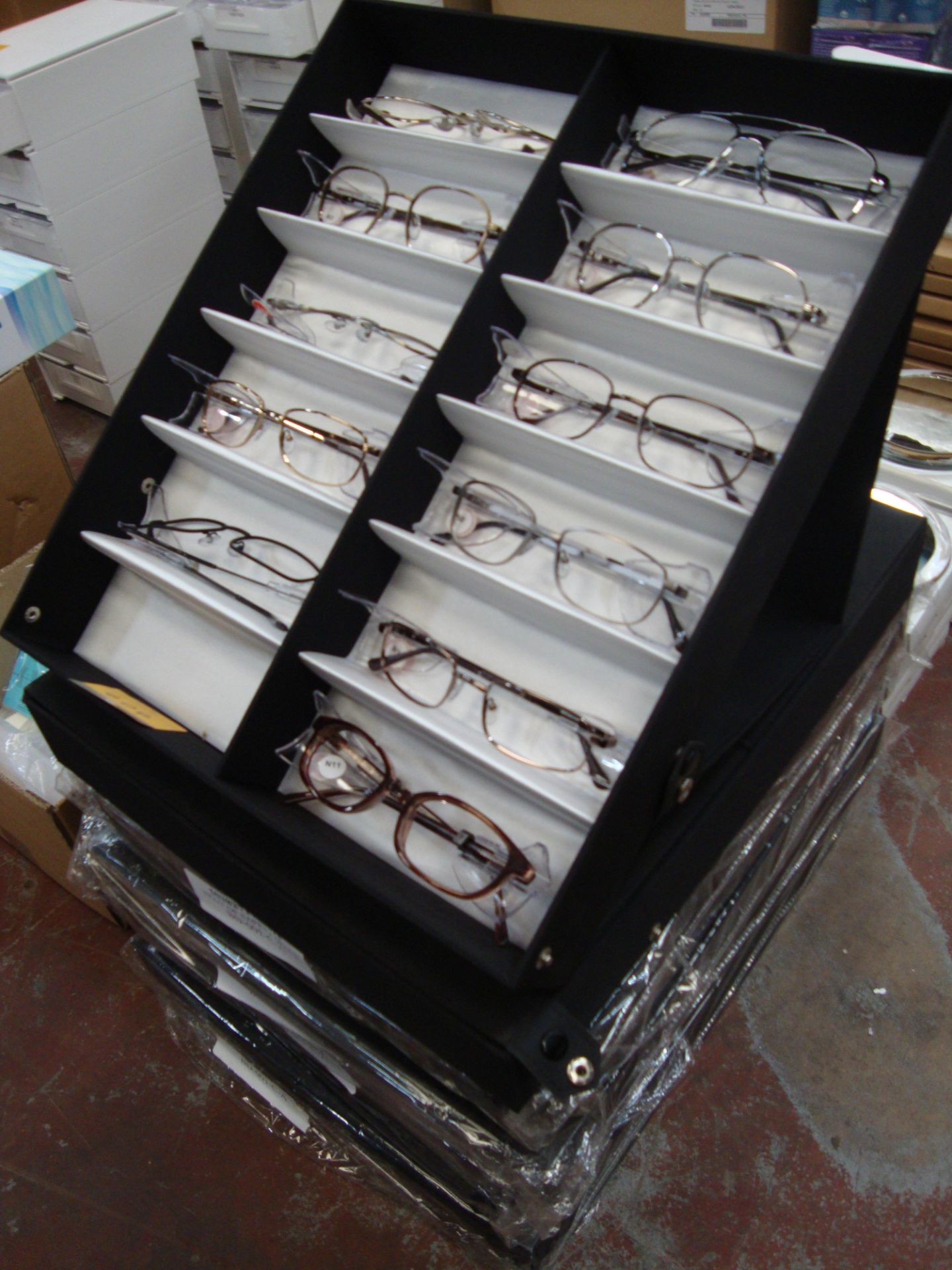 6 display cases and their contents of assorted spectacle frames All the lots in this auction are