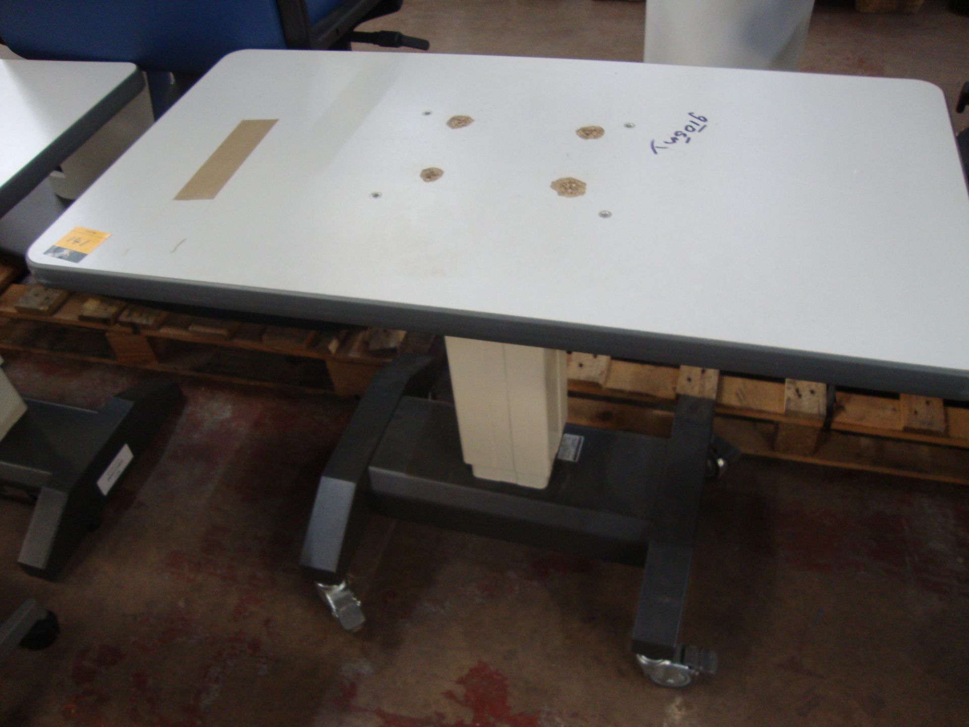 Electric motorized rising table 910mm x 490mm. NB. tabletop has pulled away from the screws that