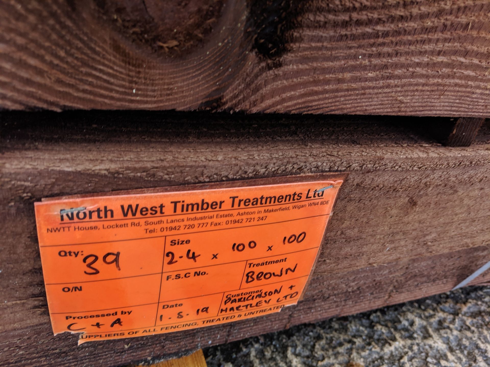 Bundle containing approximately 39 brown treated fence posts, indicated on a label as being size 2.4 - Image 3 of 5