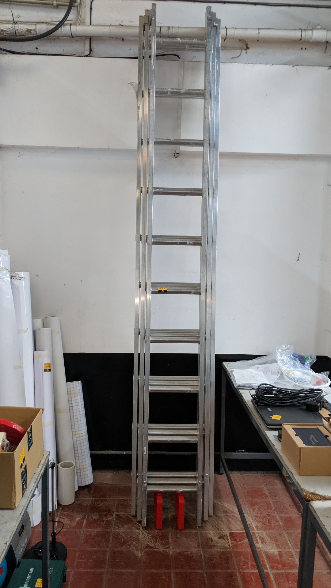 Set of triple rung ladders including wall mounting brackets, each rung measuring approximately 2.92m