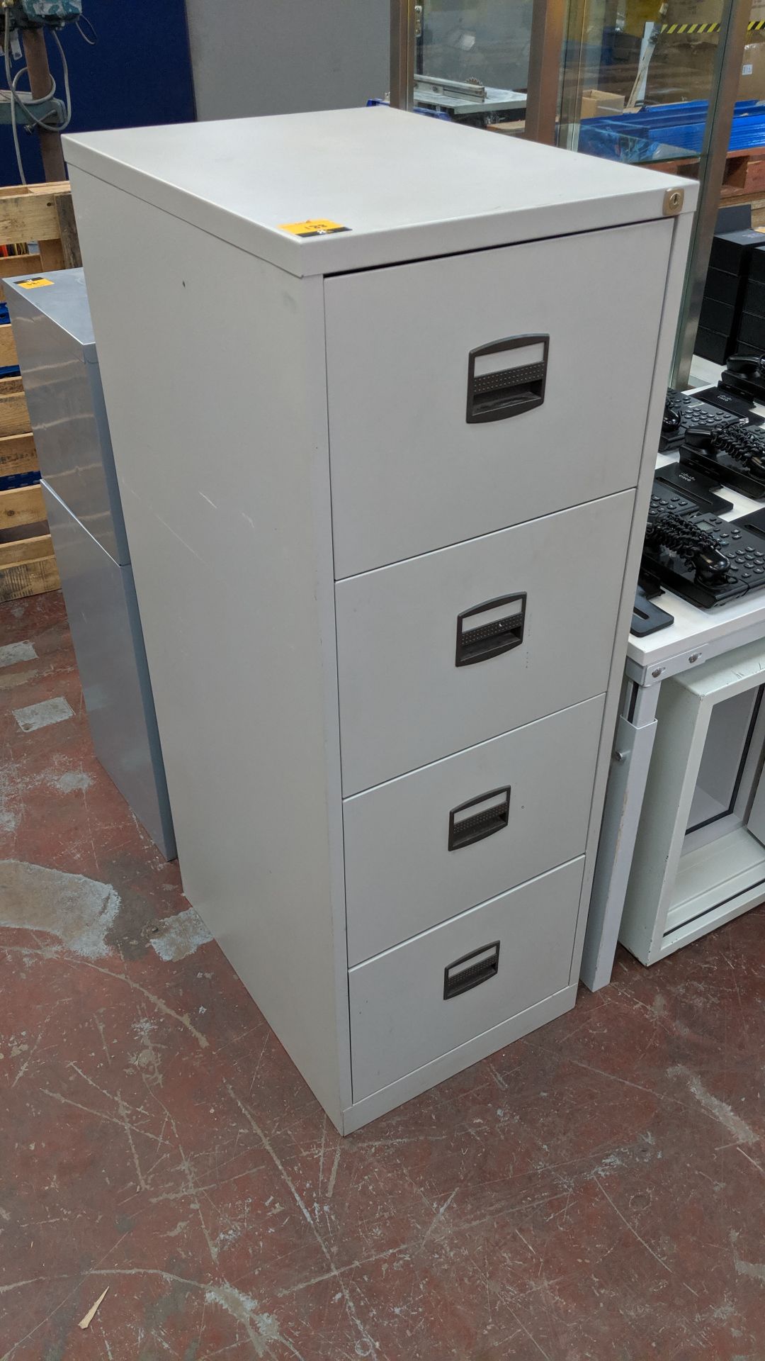 Metal 4-drawer filing cabinet. This is one of a large number of lots being sold on behalf of