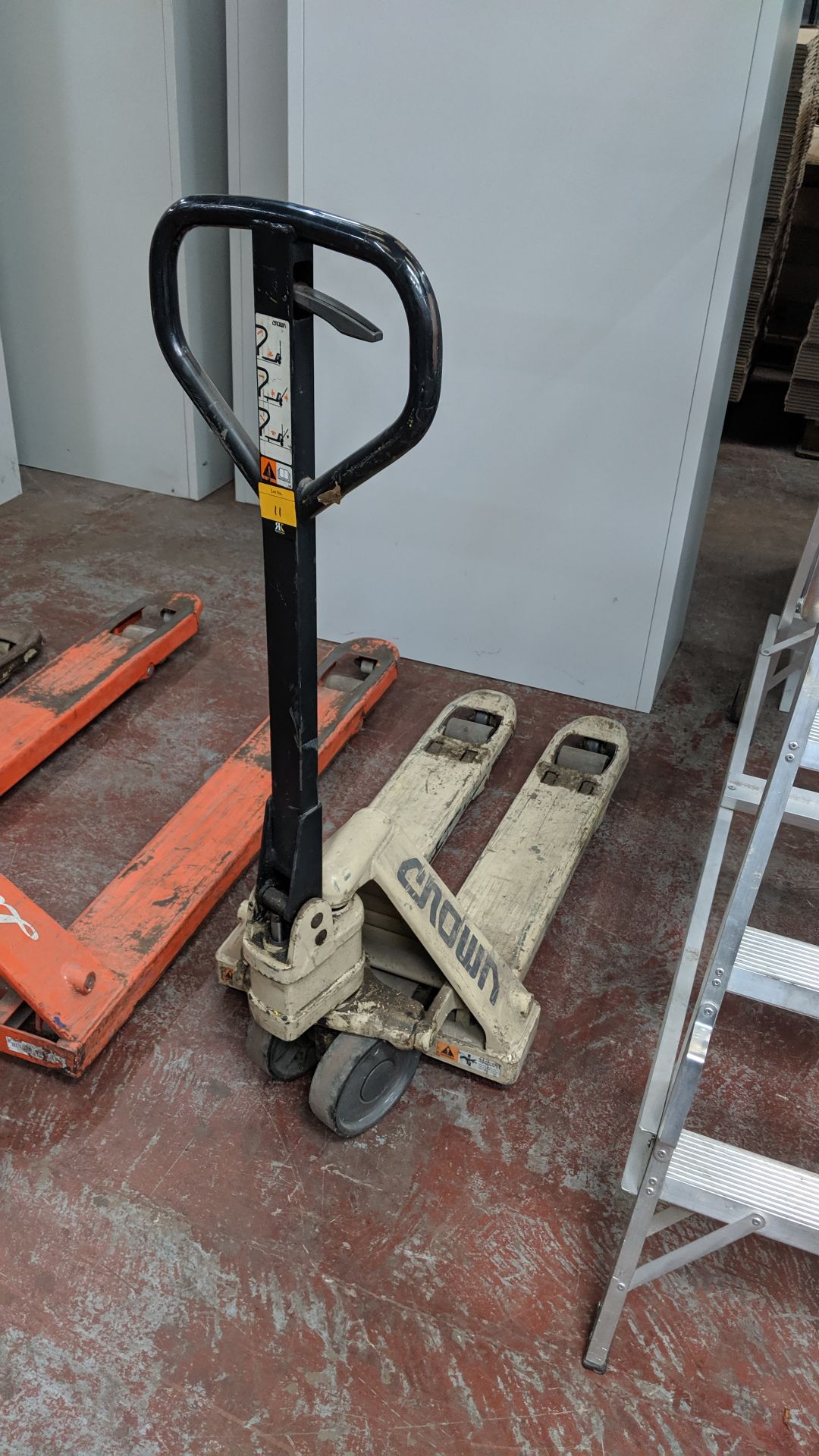 Crown small pallet truck. Smaller than a Euro pallet truck, the length of the forks/arms is