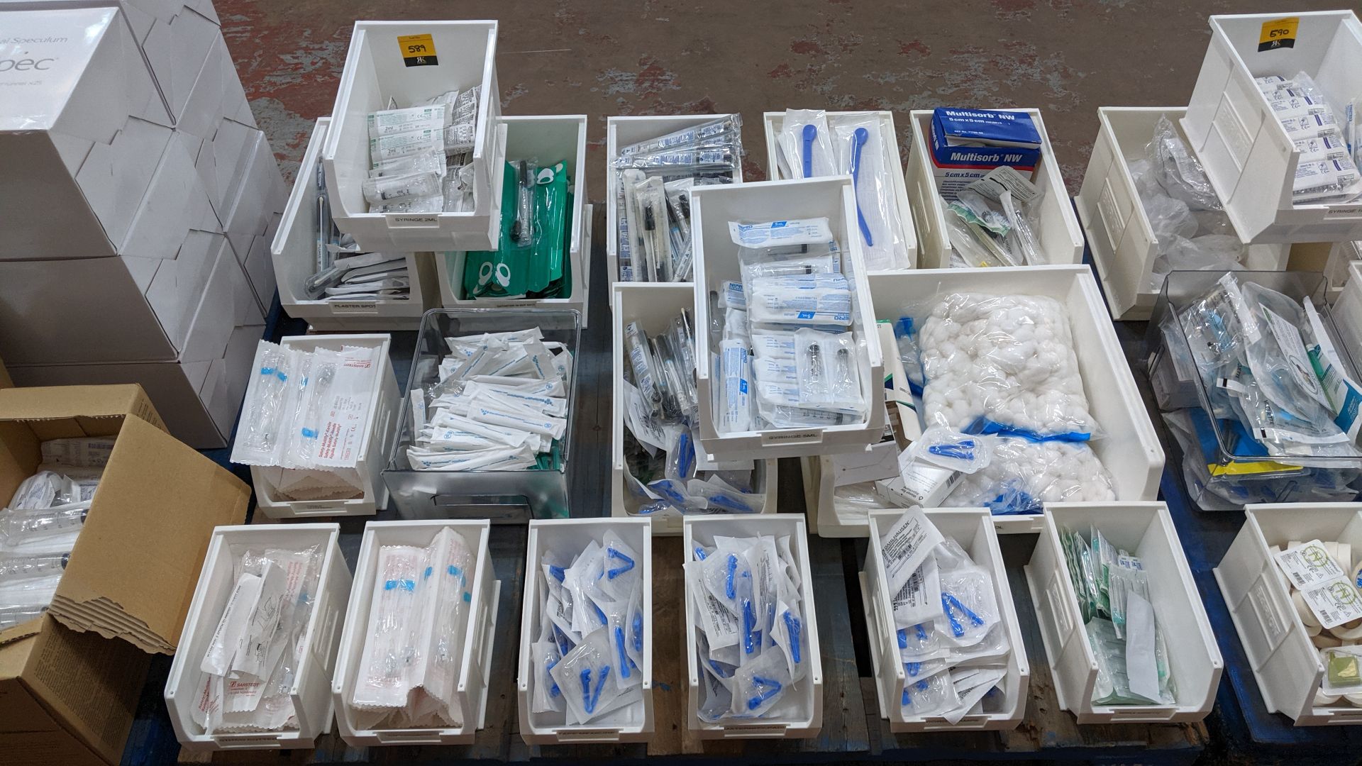 Contents of a pallet of medical supplies consisting of a large quantity of plastic bins & their