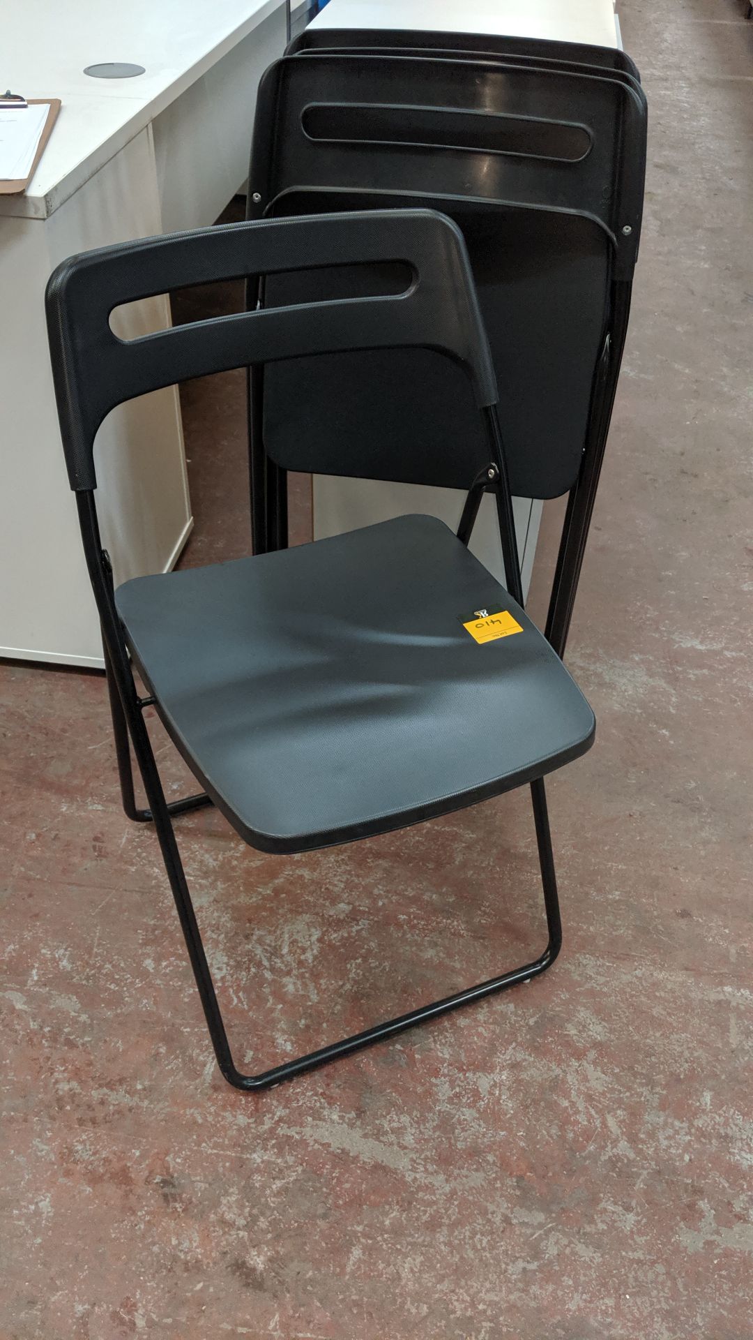 4 off black folding chairs. This is one of a large number of lots used/owned by One To One (North