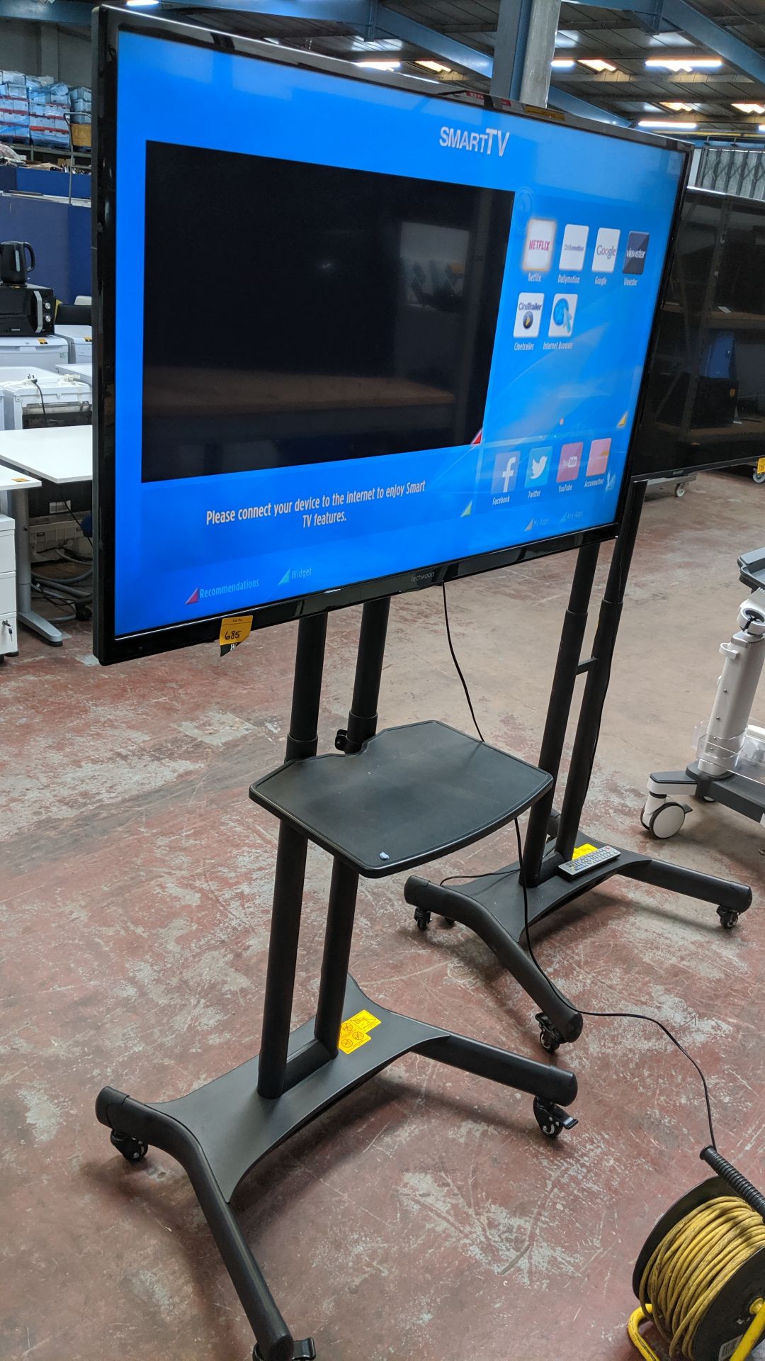 Techwood 49" widescreen LCD TV on mobile stand including shelf & remote control. This is one of a