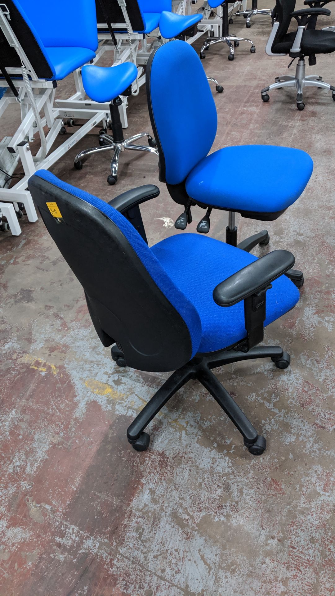 Pair of blue operator's chairs, one with arms & one without. This is one of a large number of lots