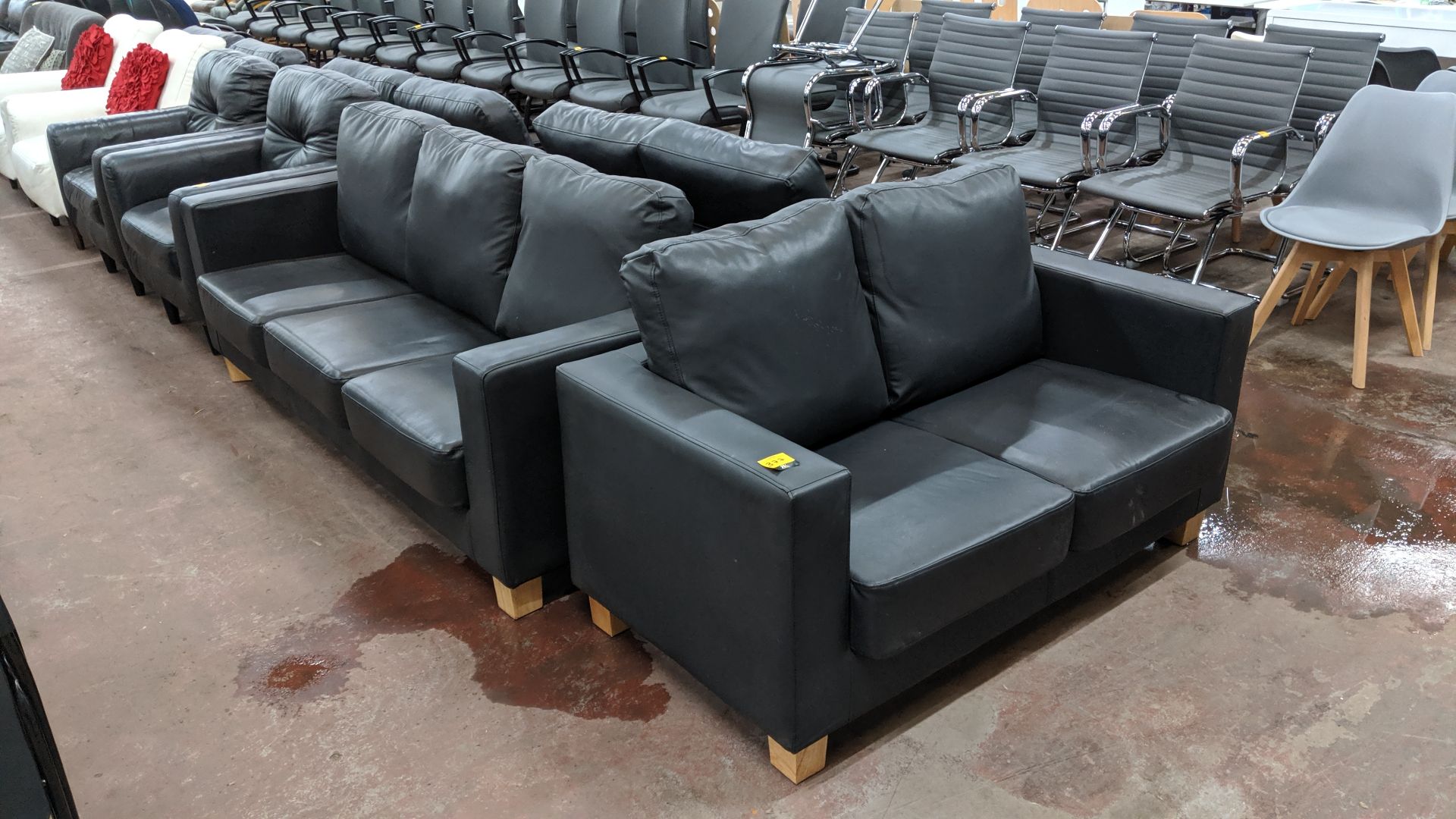 Pair of black leather-look sofas, comprising 1 off 2-seater & 1 off 3-seater. This is one of a large