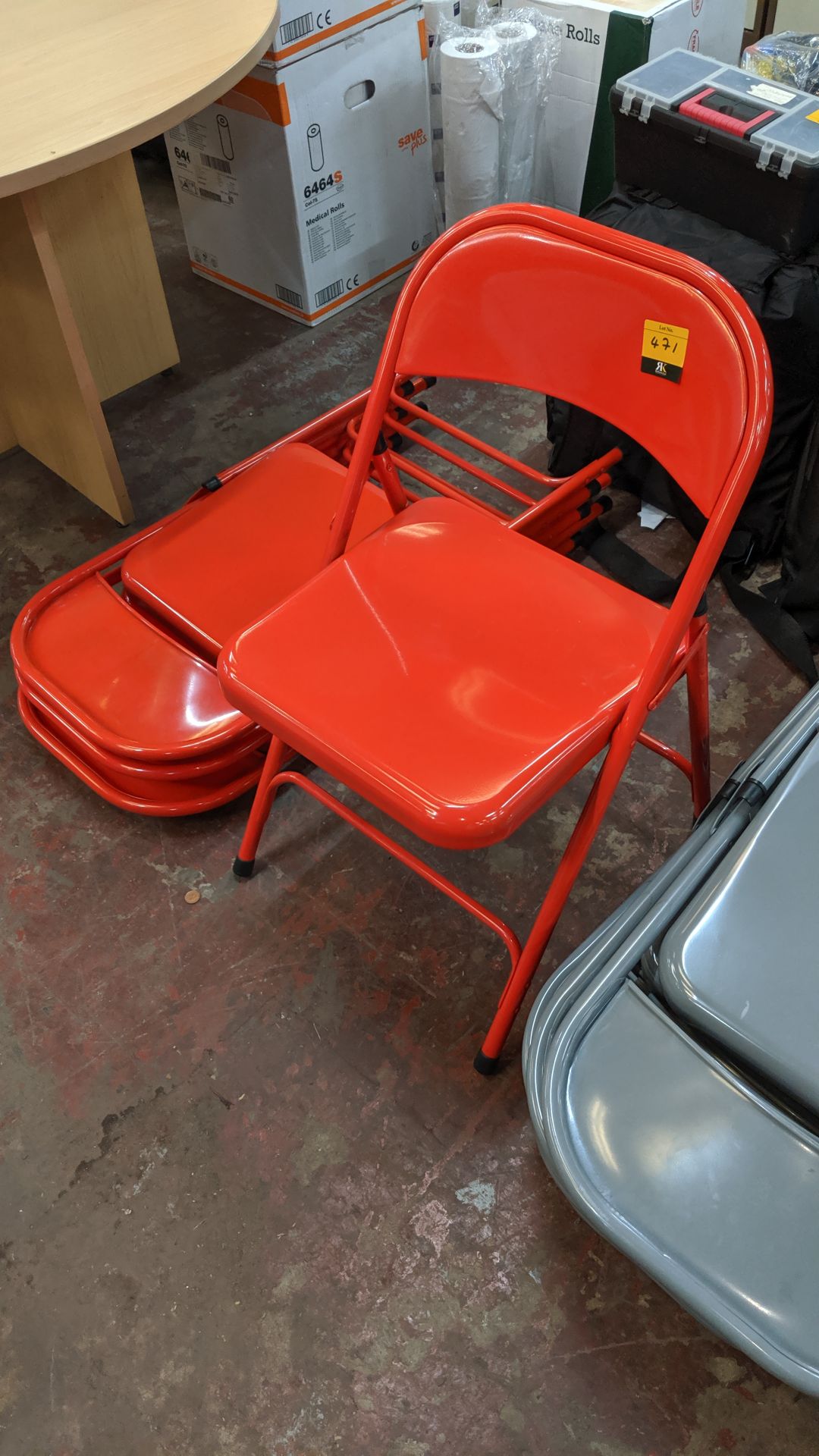 4 off red metal folding matching chairs. This is one of a large number of lots used/owned by One