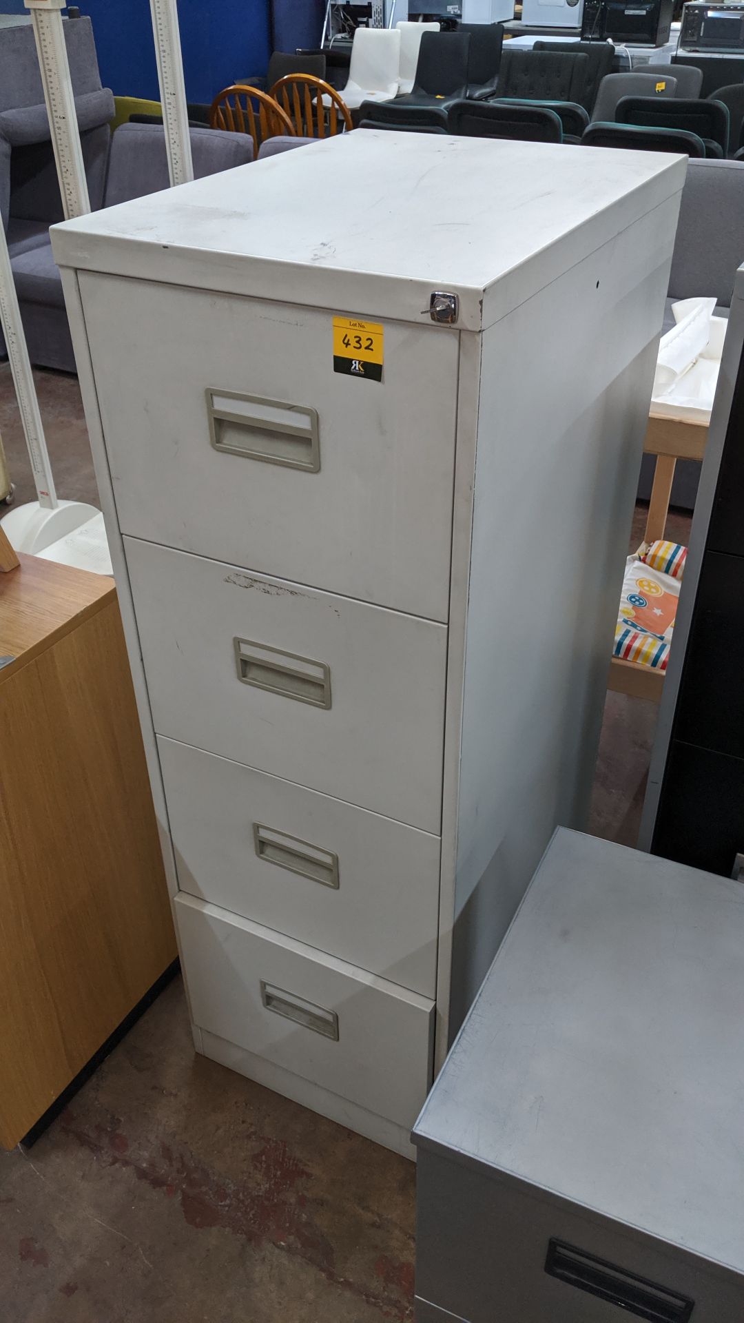 Metal 4-drawer filing cabinet with key. This is one of a large number of lots used/owned by One To