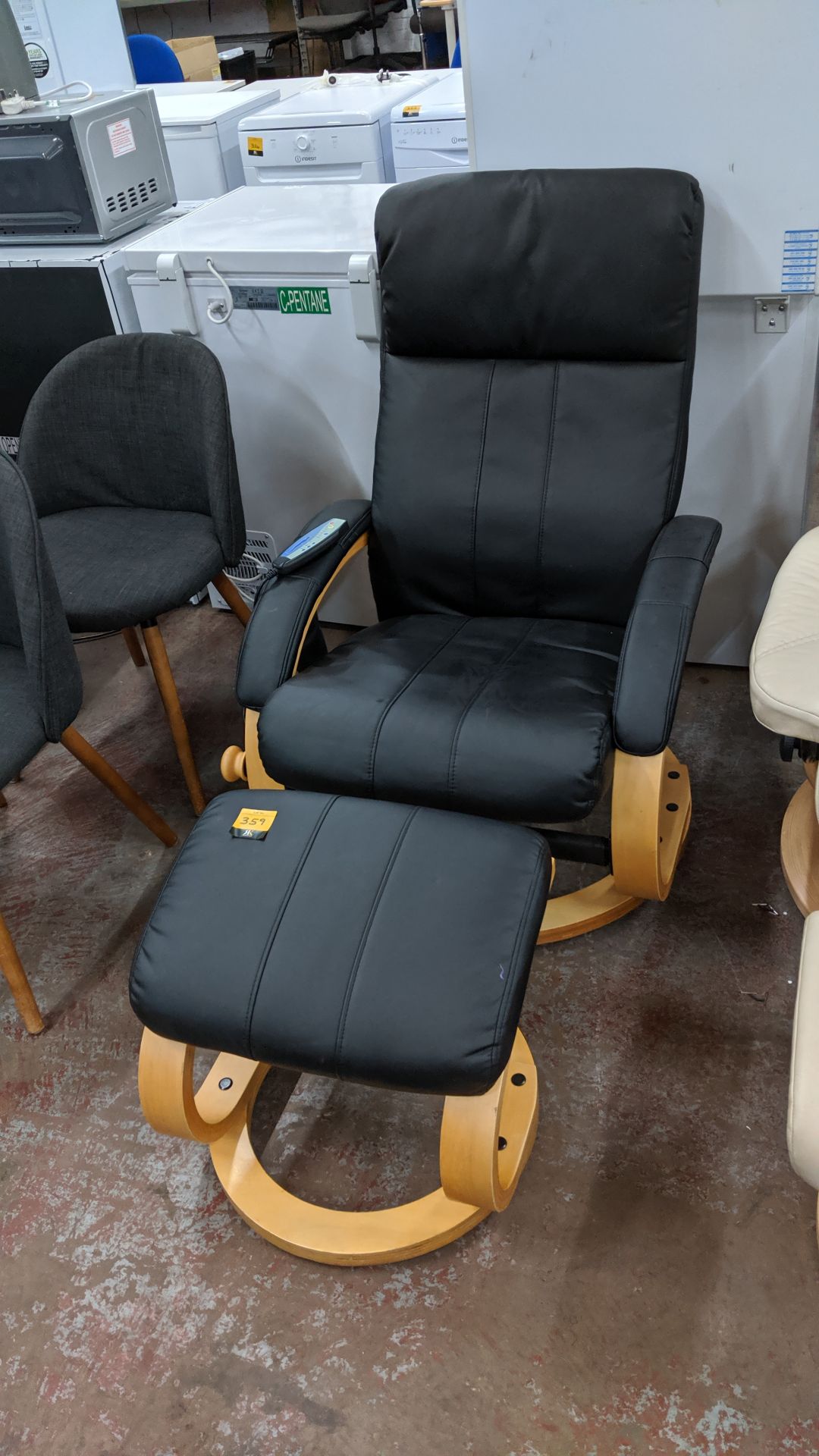 Black leather electrically operated massage chair with pocket for remote controller plus matching