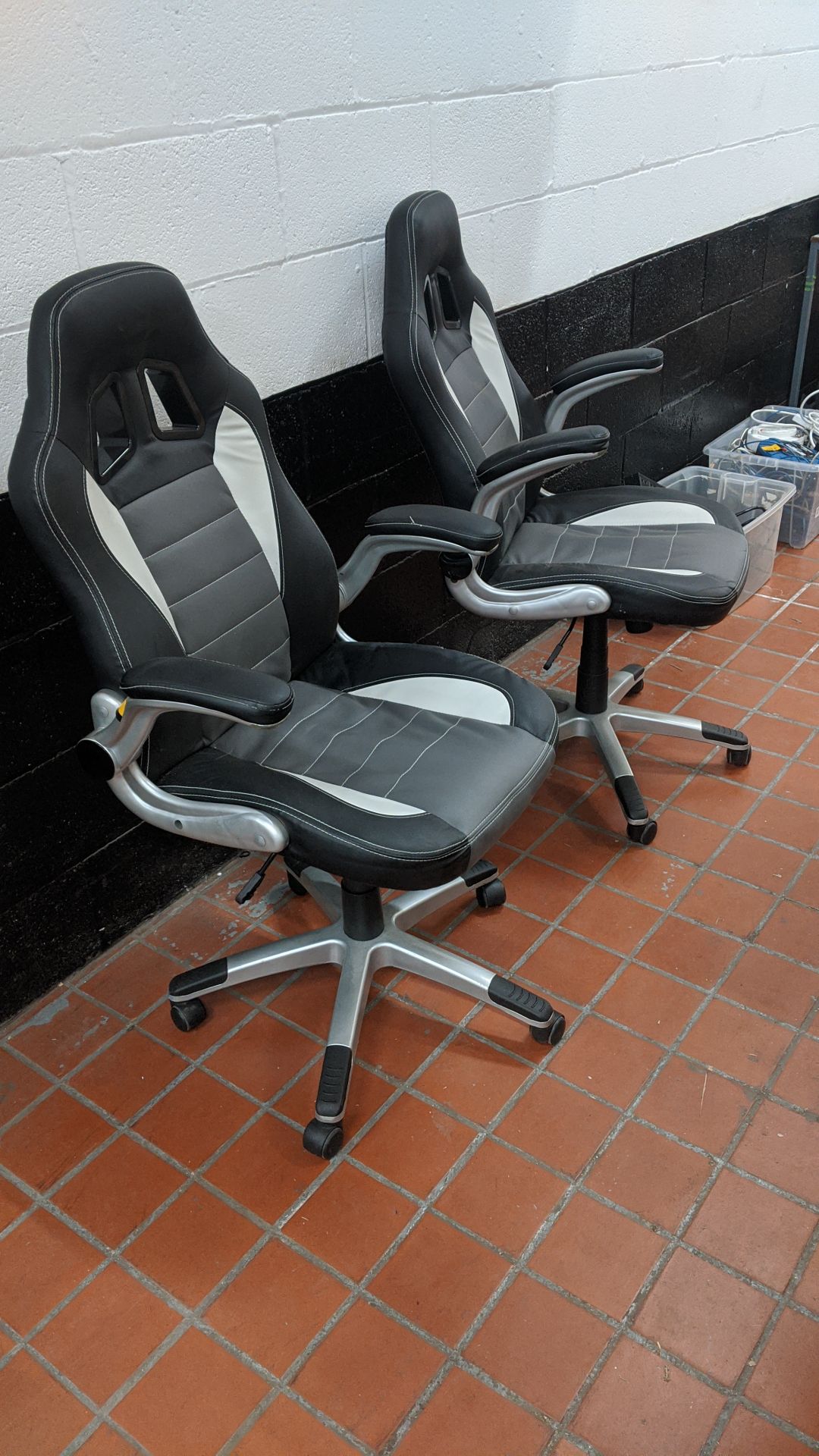 2 off motorsports style black & silver leather exec chairs. This is one of a large number of lots in