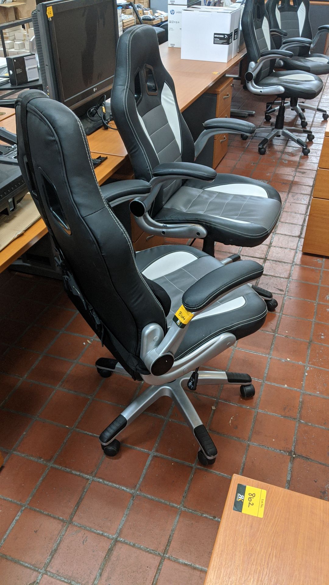 2 off motorsports style black & silver leather exec chairs. This is one of a large number of lots in