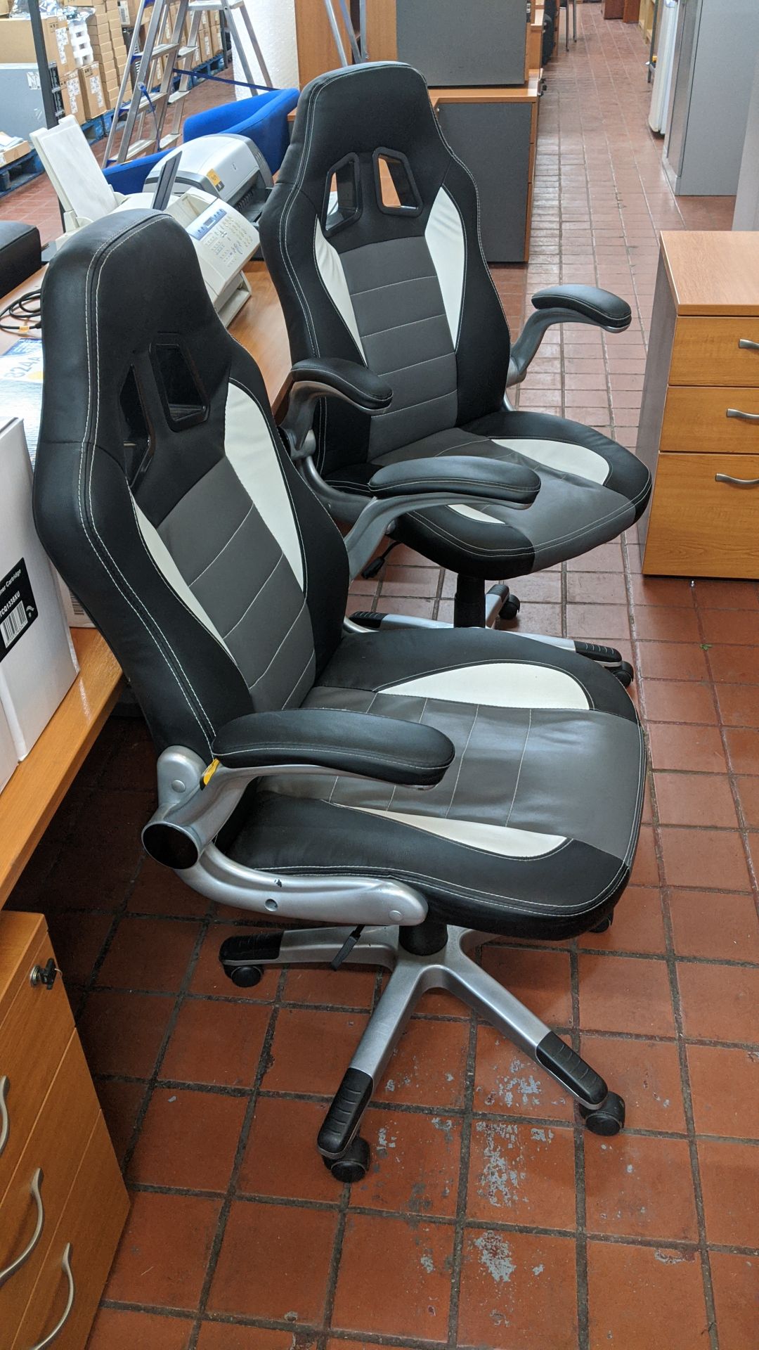 2 off motorsports style black & silver leather exec chairs. This is one of a large number of lots in