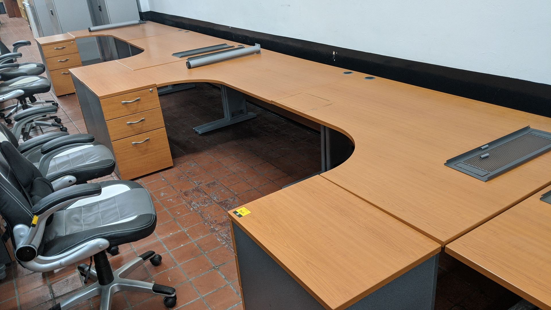 4 off curve front "piano" desks each including a matching desk height pedestal. This is one of a