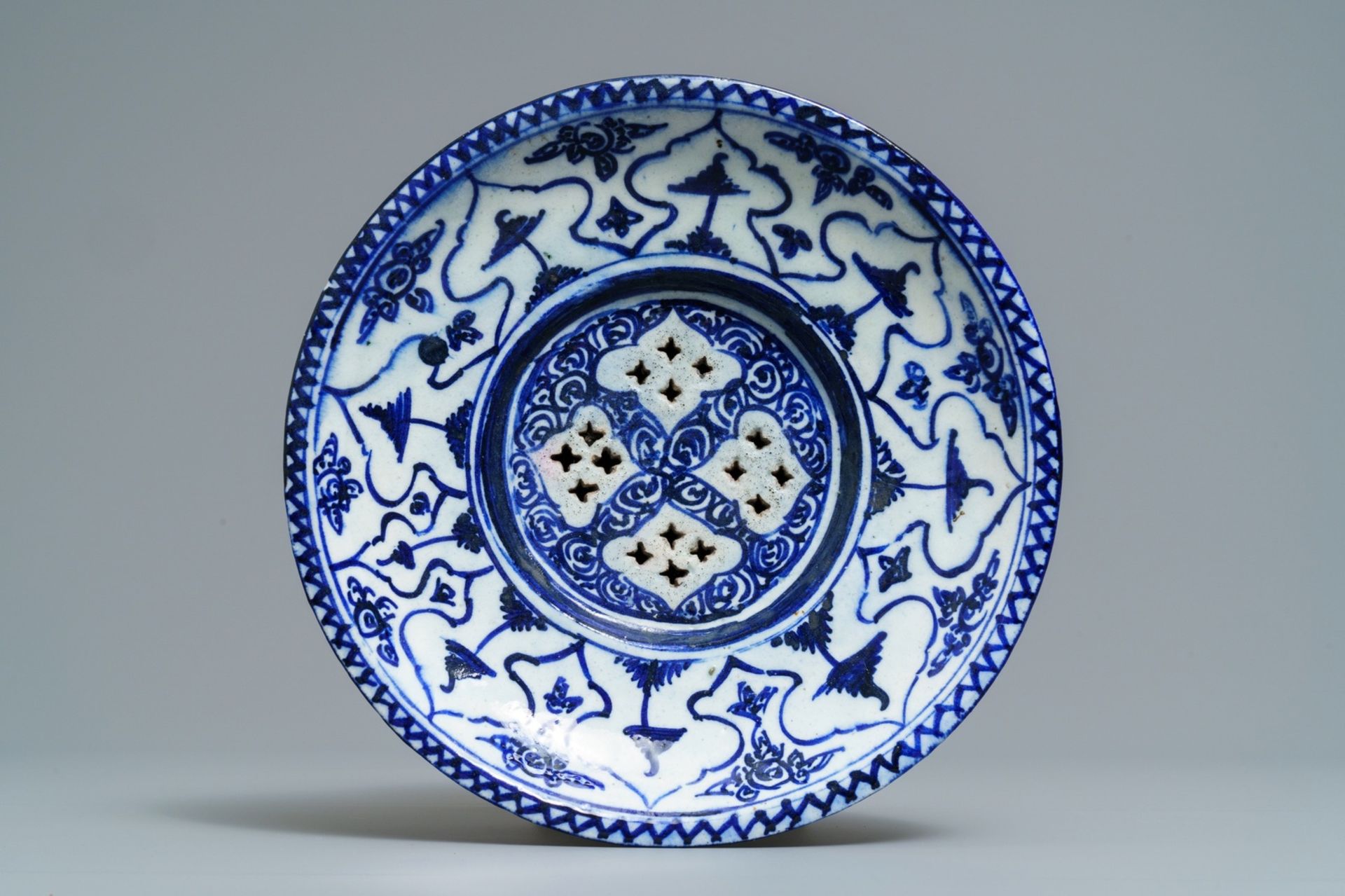 A large blue and white fritware spittoon or strainer, Qajar, Iran, 19th C. - Image 6 of 7