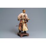 A Chinese Manchu archer doll in painted wood and textile, 19th C.