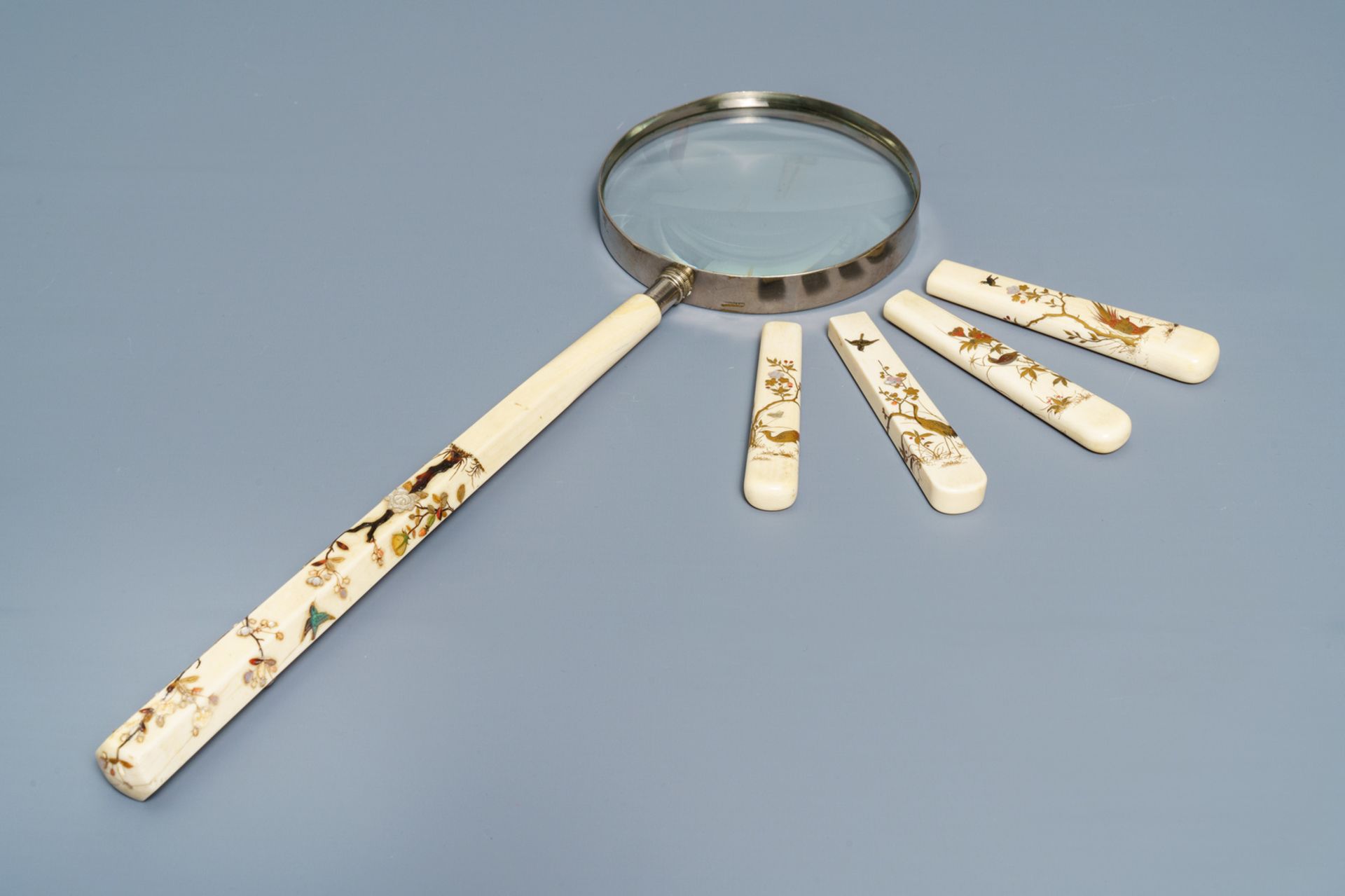 A Japanese Shibayama inlaid ivory magnifier and four handles, Meiji, 19th C.