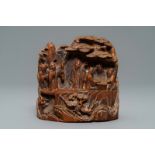 A Chinese carved hardwood group with sages in a garden, 18/19th C.