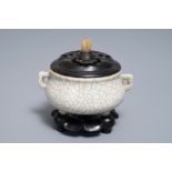 A Chinese ge-type crackle-glazed tripod censer and cover on stand, 19/20th C.