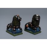 A pair of black Dutch Delft models of lions, 18/19th C.