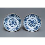 A pair of Chinese blue and white 'flower scroll' plates, Qianlong mark and of the period