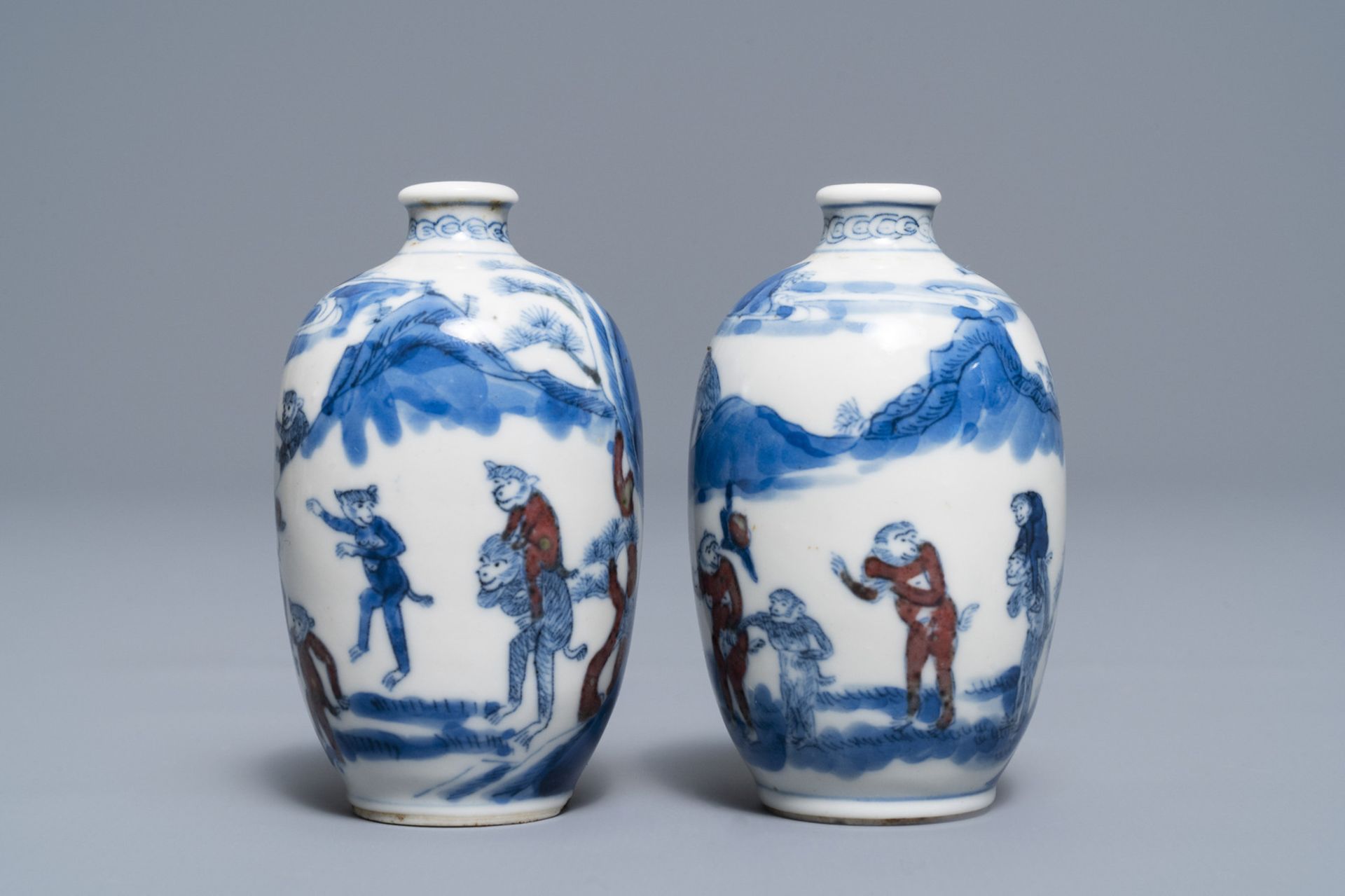 A pair of Chinese blue, white and underglaze red '16 monkeys' snuff bottles, Yongzheng mark, 19th C. - Image 3 of 7