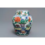 A Chinese wucai vase with vases in a garden, Transitional period