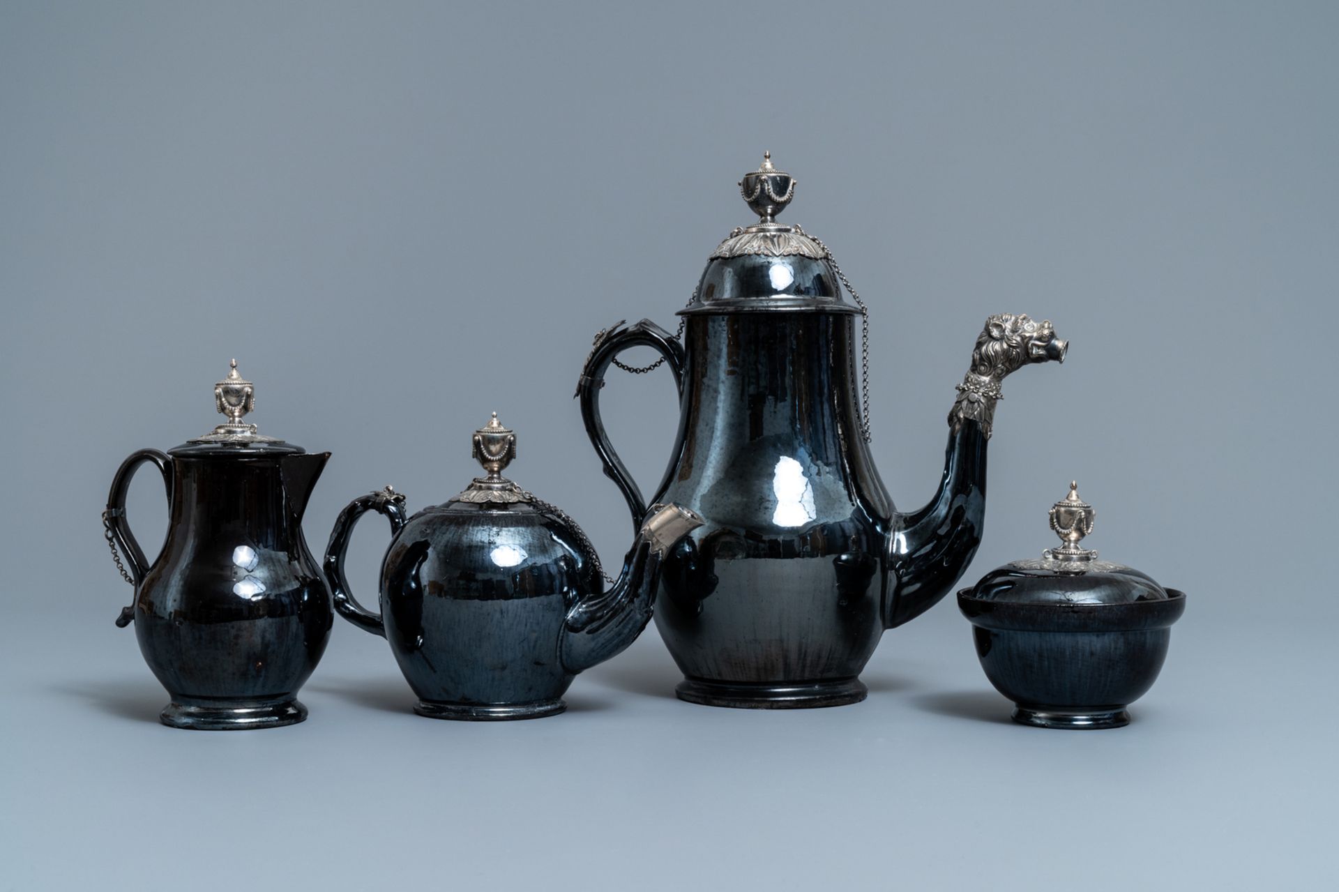 A four-piece silver-mounted Namur black-glazed pottery coffee service, 18th C.