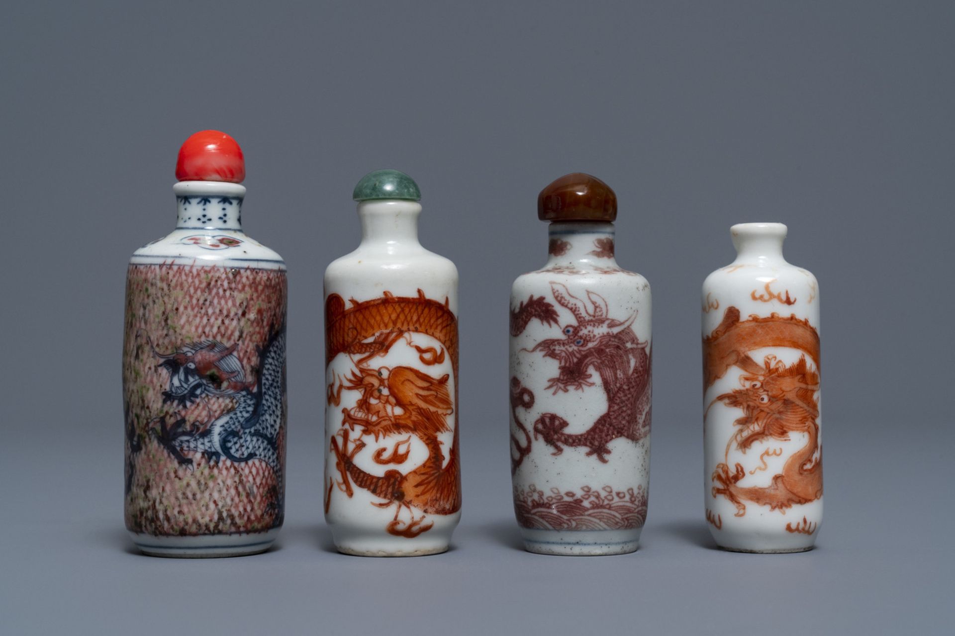 Four Chinese iron- and copper-red porcelain 'dragon' snuff bottles, 19/20th C.