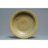 A Chinese Longquan celadon dish with incised floral design, early Ming