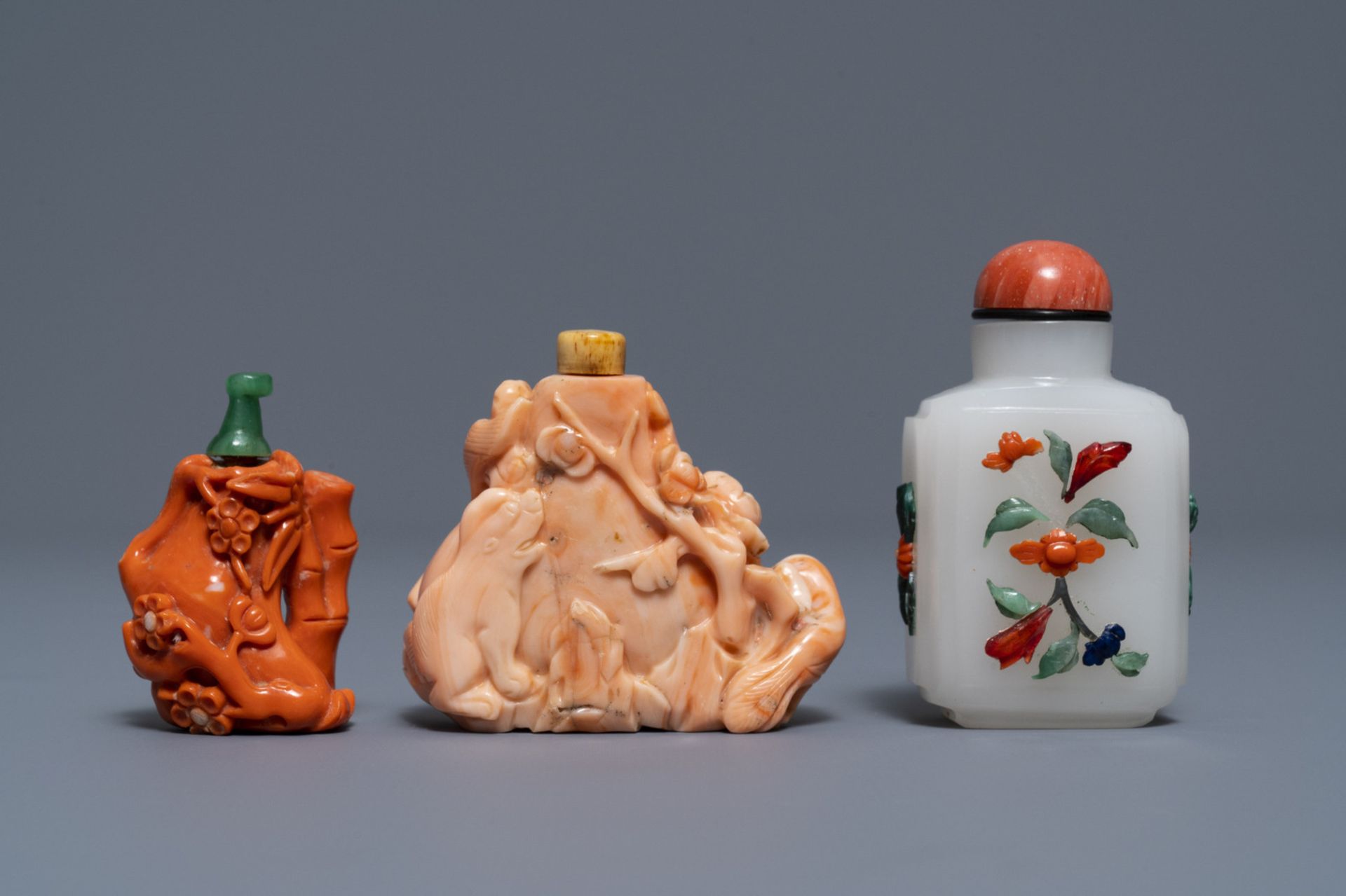 Two Chinese coral snuff bottles and one coral-embellished glass bottle, 19/20th C.