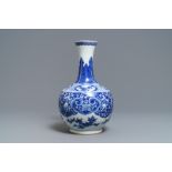 A Chinese blue and white bottle vase with dancers on a floral ground, 19th C.