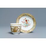 A reticulated Chinese famille rose cup and saucer, Qianlong