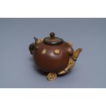 A Chinese Yixing stoneware relief-decorated teapot with nuts and fruits, Shao Er Quan mark, Daoguang