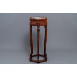 A Chinese wooden stand with marble top, 19/20th C.